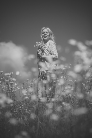 Spring, woman in chamomile field.の写真素材