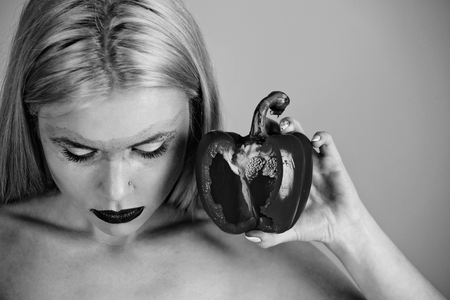 bell pepper in hand of woman with creative fashionable makeupの写真素材
