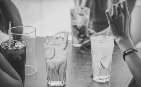 women drink cocktail with ice cube. Cocktails mix with fruit for girls party in bar. Thirst and refresh. Bar and restaurant, cocktail party. Party and summer vacation.の写真素材
