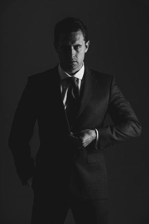 ceo. businessman or man manager with serious face and stylish hair, haircut posing in fashionable blue formal suit on grey background. Business, fashion and successの写真素材