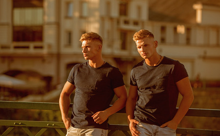Fashion for muscular guys doesnt have to be tricky. Pair of twins with muscular look. Muscular men in good physique. Athletic men. Fashion twins with fit body. Handsome twins in casual fashion style.の写真素材