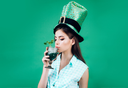pretty girl in vintage style. retro woman drink summer cocktail. St. Patricks Day pin up woman with trendy makeup. pinup girl with fashion hair. Let the party beginの写真素材