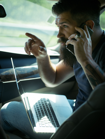 being late. rush hour. lack of time. deadline. Mature hipster with beard. Male barber care. Bearded man. brutal caucasian hipster with moustache. Multitasking.の写真素材