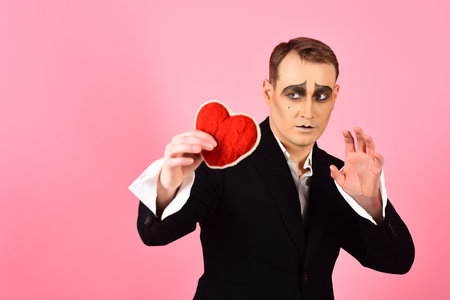 His story of boundless love. Theatre actor pantomime falling in love. Mime actor with love symbol. Mime man hold red heart for valentines day. Love confession on valentines day.の写真素材