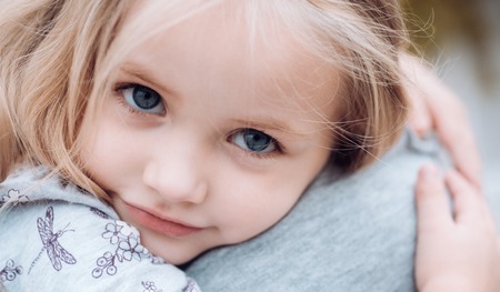 Childrens day. Small baby girl. Summer. Mothers day. New life concept. Family values. I love you. Little girl embrace her mother. Love in family. Childhood. Love you mom.の写真素材
