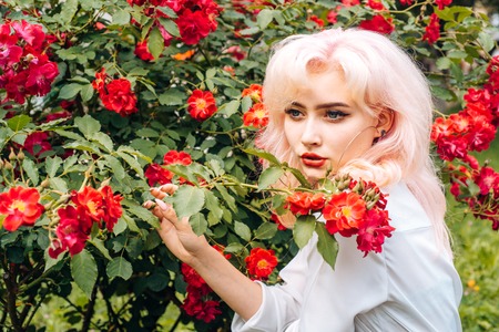 girl with summer makeup. Spring woman with flowers. Summer beauty. Makeup cosmetics and skincare. Fashion portrait of woman. hair coloring. Express positivity.の写真素材