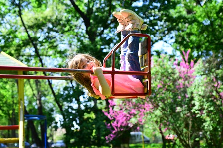 romantic little girl on the swing, sweet dreams. Small kid playing in summer. childhood daydream...