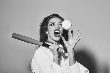pretty sexy woman with long hair holds green baseball batの写真素材