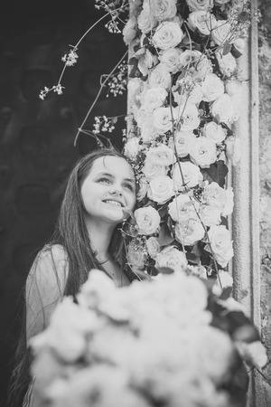 Cute little girl smile with yellow rose flowersの写真素材