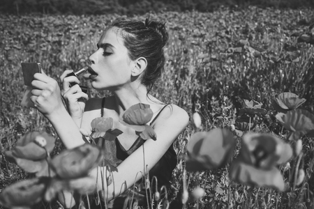 Beauty Fashion Model Woman with Red Poppy Flowersの写真素材