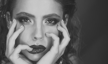 Beauty. Beautiful woman face with chic lips close up. Bright makeup and hairstyleの写真素材