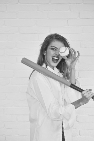 pretty sexy woman with long hair holds green baseball batの写真素材