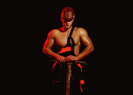 Closed for renovations, under construction. Construction worker. Man miner with mining equipment. Mining area under construction. Muscular man worker. Hard worker with muscular torsoの写真素材