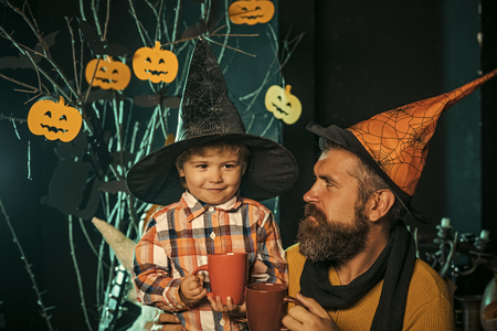 Halloween man and child in witch hat.の写真素材