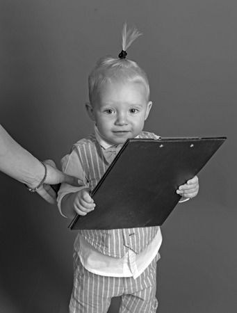 Busy cutie. Small child. Small baby boss. Adorable child manage business. Boy child plan startup business strategy. Developing startup companyの写真素材