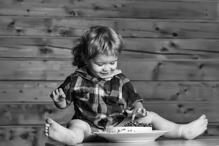 Cute boy eats cakeの写真素材