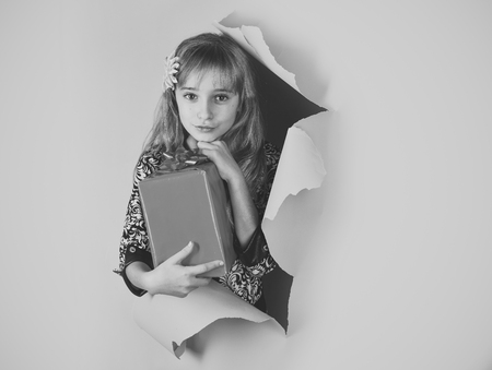 Birthday and christmas. Child girl with present pack, cyber monday. Childhood and happiness, gift box. Small girl with shopping package, black friday. Boxing day, holiday celebration and party.の写真素材