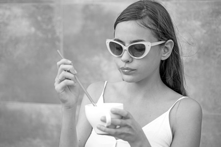 Start the day with great taste. Pretty woman sip beverage with drinking straw. Cute woman drink through straw in cafe. Fashionable woman enjoy sipping drink through straw. Savor the flavor.の写真素材