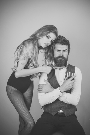 Bearded man drink whiskey, sexy woman with long curly hair.の写真素材