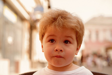 Do I care about my hair. Little child with stylish haircut. Little child with short haircut. Small boy with blond hair. Healthy haircare tips for kids. Haircare products. I love my hair.の写真素材