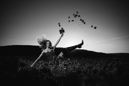 pretty dancing girl in field of poppy seedの写真素材