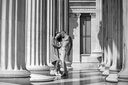 loving couple standing in the columns in sunlight.の写真素材