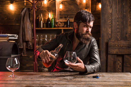 Do not drive drunk. Stop drinking. Handsome man holding a glass of whisky.の写真素材