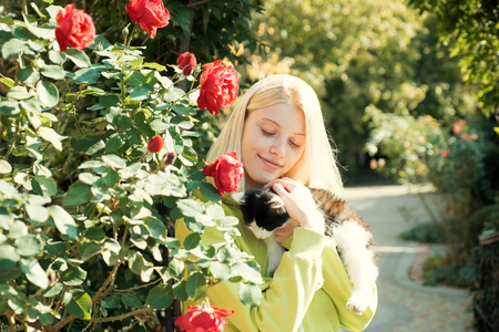 Fluffy kitten. Enjoy autumn season. Autumn is here. Pretty woman carry cat animal. Woman love animals nature background. Warmth and coziness. Happy autumn day with friend. Adorable girl hug catの写真素材