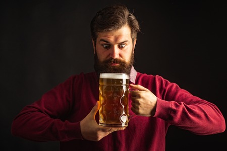 Man with beard drink beer. Bearded man drinking lager beer. Concept of craft beer. Beer in Belgium.
