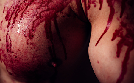 Aggressive person. Injured soldier. Chest muscular torso with bloody streams. Pain and gain. Pain and injury. Body soiled blood. Mutant concept. Psycho mad man. Murderer brutal aggressive guyの写真素材