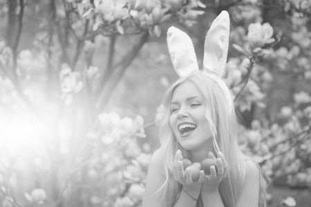 happy girl with easter eggs in bunny earsの写真素材
