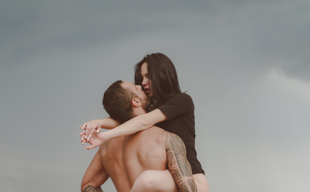 Love story. Beautiful young couple hugging. Couple is hugging. Passion love couple. Handsome muscular guy and amazing sexy woman. Cosmopolitan couple. Love and flirt.の写真素材