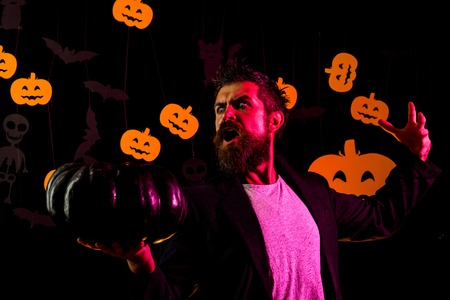 Magic, enchantment, witchcraft. Wizard, sorcerer, warlock. Scary hipster with beard in witch hat and plaid shirt. Halloween, holidays celebration.の写真素材