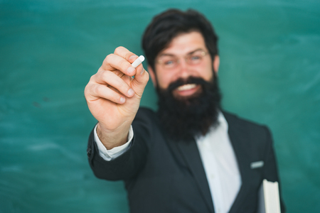 Knowledge day. Teacher job - profession and learning concept. Tired stressed and depressed professor near blackboard. Preparing for exam in college.の写真素材