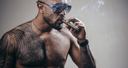 Brutal sportsman torso. Sport and fitness. Confidence and charisma. Sexy abs of tattoo man. Muscular macho man with athletic body. Vapeの写真素材