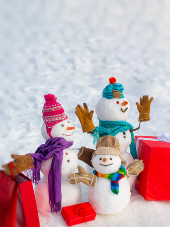 Snowmen family - gift presents concept. Winter Sale banner. New year gift. Santa Claus gifting gift. Christmas snowman with shopping bag and Christmas gift.の写真素材
