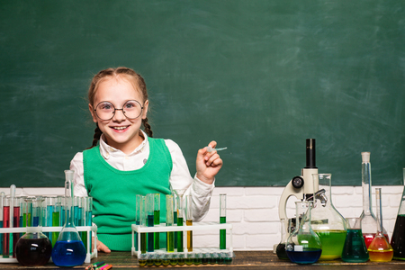 Back to school. Child from elementary school. A chemistry demonstration.の写真素材
