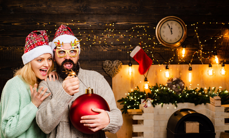 Christmas happy family. Christmas Santa with bomb. Christmas Celebration holiday. Christmas man in fashion red dress hold bomb. Bomb emotions. Portrait of group smiling friends.の写真素材