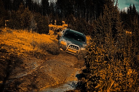 Safari suv. 4x4 travel trekking. Off road sport truck between mountains landscape. Travel concept with big 4x4 car. Road adventure. Adventure travel. Expedition offroader.の写真素材