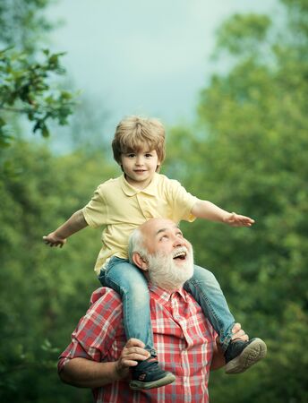 Grandfather and his grandson playing outdoors. Family holiday and togetherness. Generation. Grandfather and grandson in the park.の写真素材