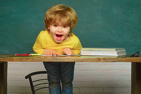 Education. Cheerful smiling child at the blackboard. Hard exam. Schoolchild. Happy smiling pupils...
