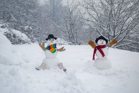 Happy winter time. Christmas party people. Two Happy smiling snowman on sunny winter day. Sensual snowman couple enjoying intimacy. Passion dating and love.の写真素材