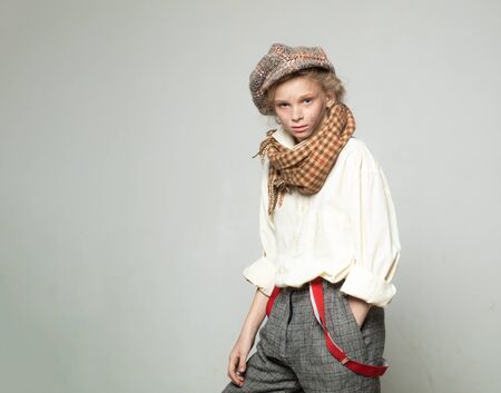 old fashioned child in beret. retro fashion model. Vintage suspender. street kid with dirty face....