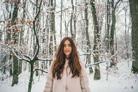 Beauty Winter Girl in frosty winter Park. Winter woman fan. Winter woman snow. Outdoors.