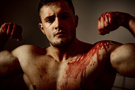 Pain and injury. Aggressive monster. Body soiled blood. Mutant concept. Psycho mad man. Psychic disease. Murderer brutal aggressive guy. Halloween actor. Aggressive person. Injured soldierの写真素材