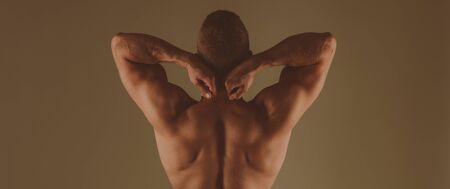 Strong and powerful. Man muscular back brown background. Athletic bodybuilder muscular divine man....