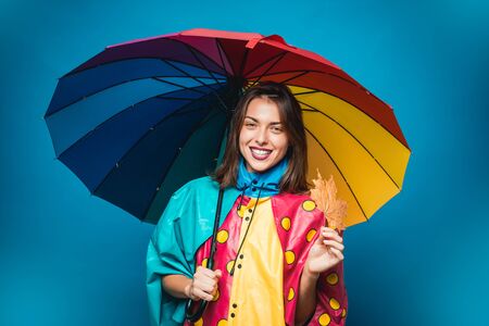 Attractive young woman in a seasonal clothes with golden leaf. Autumn mood and the weather are warm and sunny and rain is possible. Autumn concept. Girl in autumn are getting ready for autumn sale.の写真素材