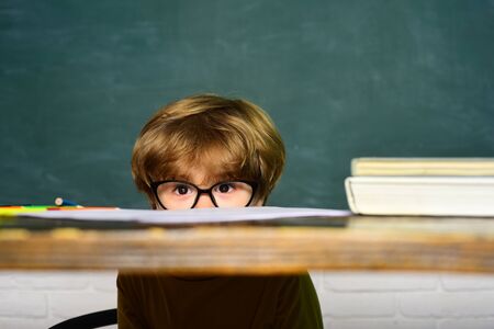 Talented child. School kids against green chalkboard. School children. Kids school. School concept.