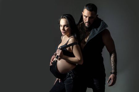 brutal couple in love. family bonding. pregnancy. pregnant woman with muscular macho man. man and...