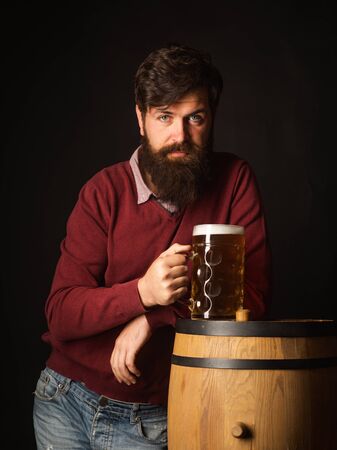Beer in the US. Concept of craft beer. Brewer. Beer in the UK. Man with beard drink beer.